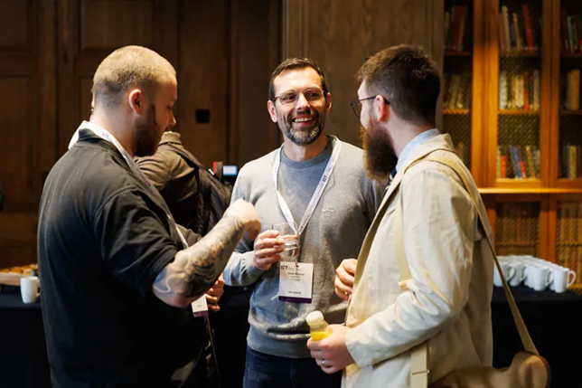 three-people-with-drinks-chatting