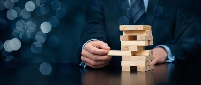 hand pulling out jenga blocks